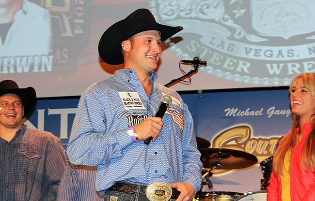 Kyle Irwin smiles on the South Point stage during the go-round buckle ceremony after the third round of the 2014 National Finals Rodeo. Irwin hopes to return to the round-buckle ceremony at this year's NFR. 