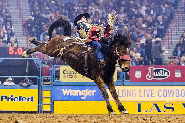 Ty Breuer spurs Pete Carr Pro Rodeo's Dirty Jacket for 86.5 points to place during Saturday's 10th round to close out his best Wrangler National Finals Rodeo. (TODD BREWER PHOTO)