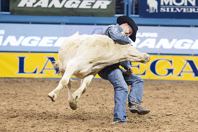 Kyle Irwin wrestles his steer to the ground in 3.4 seconds to win Saturday's third round of the Wrangler National Finals Rodeo. (TODD BREWER PHOTO)
