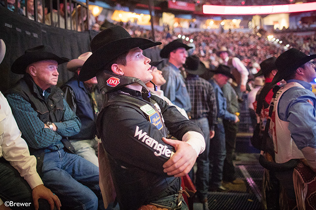 Tanner Aus watches the replay of the action during Tuesday's sixth round of the Wrangler National Finals Rodeo. He has placed in two go-rounds so far. (TODD BREWER PHOTO)