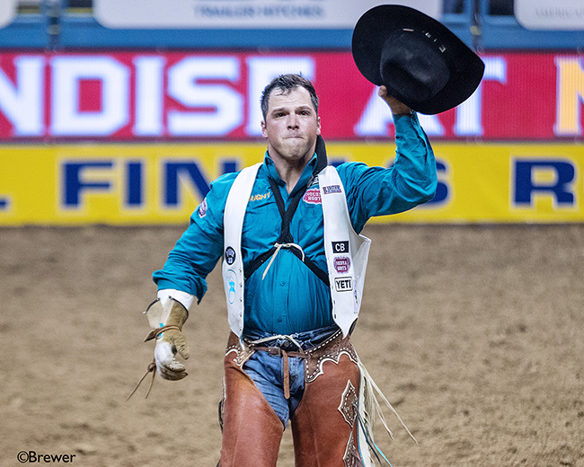 Richmond Champion celebrates after his 88-point ride Thursday to win the eighth round of the Wrangler National Finals Rodeo. (TODD BREWER PHOTO)