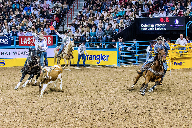 Coleman Proctor, right, turns the steer for his heeler, Billie Jack Saebens, during their 3.9-second run during Friday's ninth-round of the Wrangler National Finals Rodeo. (TODD BREWER PHOTO)